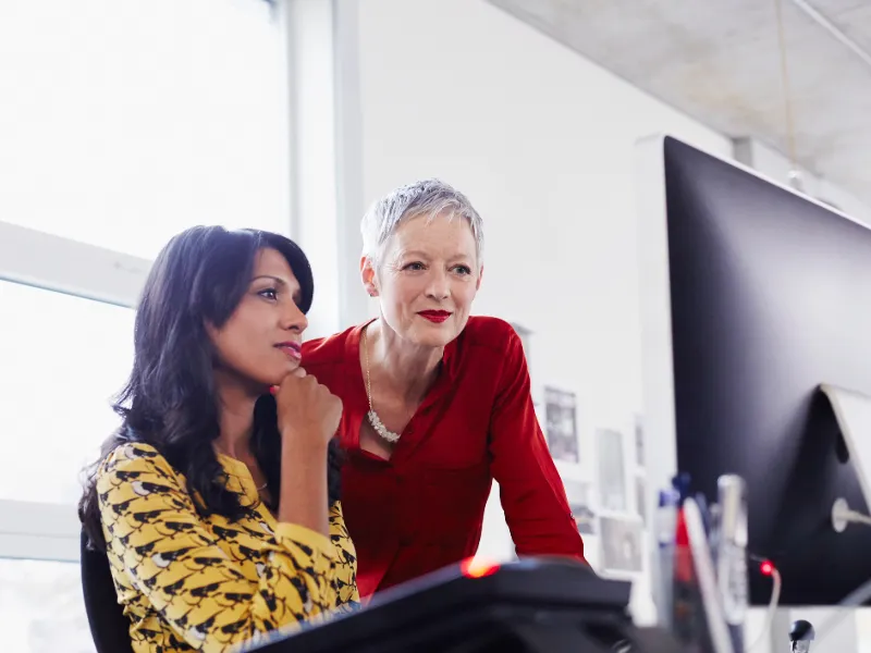 mature business woman mentoring younger employee 528913575 embed