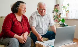 Welfare and employability- older couple at home looking at laptop- 800*600