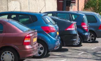 Cars parked in row on outdoor parking