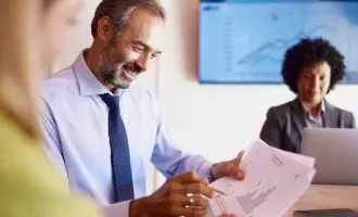 Businessman analyzing reports with his colleague