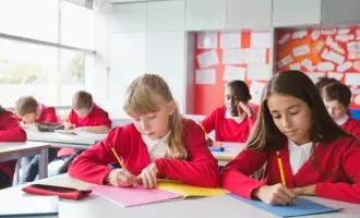 Students writing in classroom