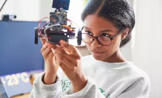 Learning & development -Teenage girl building robot