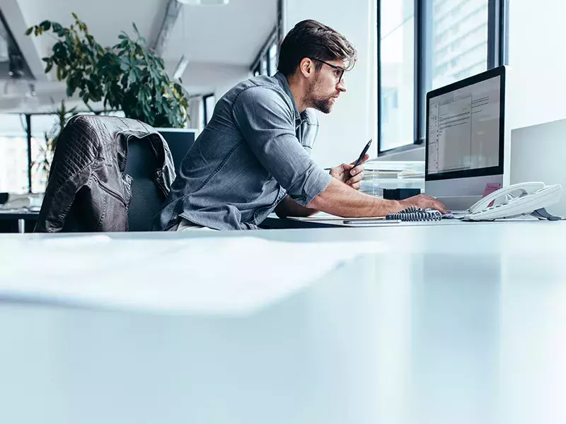 Automation Man looking at laptops