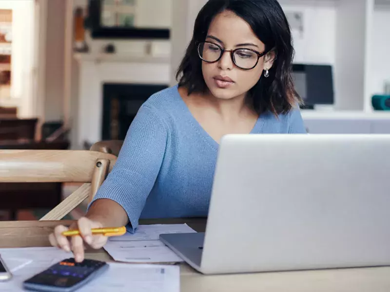 Accounting software Woman calculating budget at home