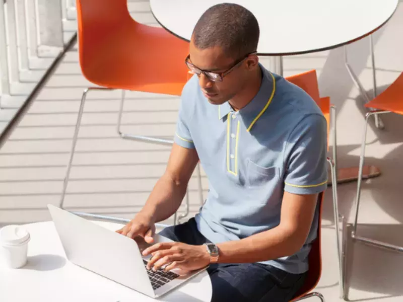 Apprenticeship programmes Student working on laptop outside