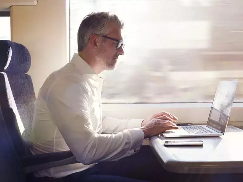 AI for the first line of defence man with laptop in train